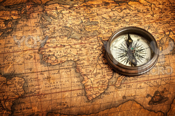 Old vintage compass On ancient Map Bc